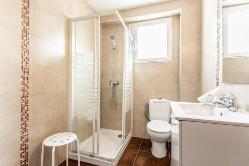 a bathroom with a shower and a toilet and a sink at Casa Victoria in Valencia