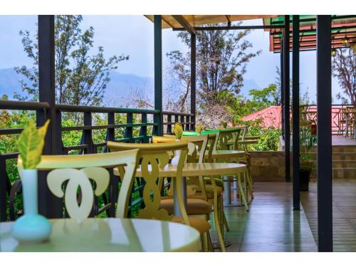 a row of tables and chairs on a patio at Wigot Gardens Hotel in Kisumu