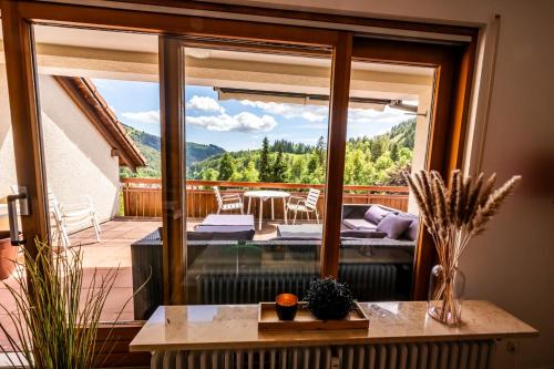 a balcony with a view of the mountains from a house at Ferienwohnung am Letzberg in Schönau im Schwarzwald