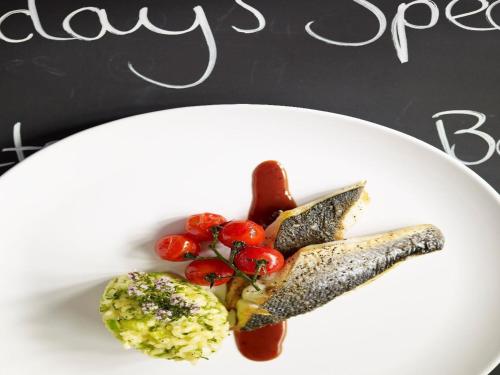 um prato de comida com peixe e legumes em Gilbey's Bar, Restaurant & Townhouse em Windsor