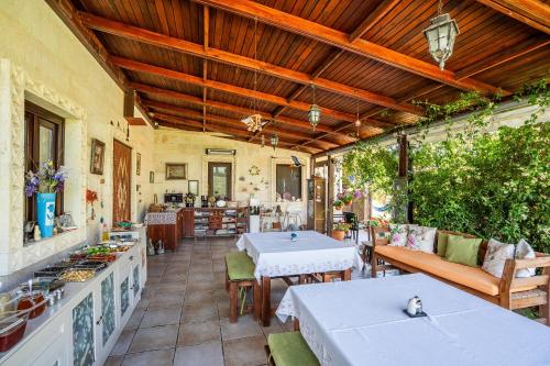 an outdoor patio with two tables and chairs at Bagbadem Tatil Çiftliği in Bozcaada