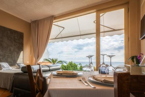 a dining room with a table with a view of the ocean at La Risacca Relais in Belvedere Marittimo
