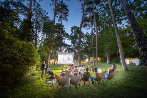 a group of people sitting in chairs in the grass at Huttopia Rambouillet in Rambouillet