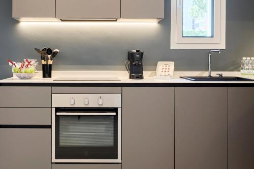 a kitchen with a stove and a counter top at Luxury Home Ceccarini - Lungomare con parcheggio privato in Riccione