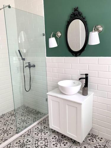 a bathroom with a sink and a shower with a mirror at Terrace Room on Parish Street in Luqa