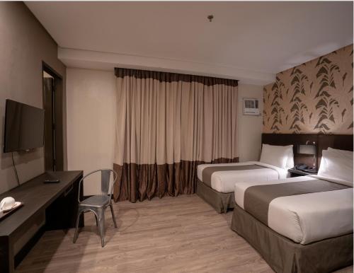Ліжко або ліжка в номері GT Hotel Jaro