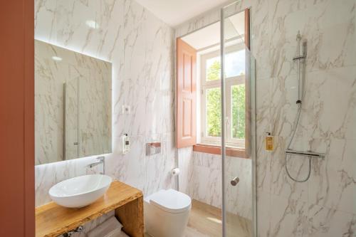 a bathroom with a sink and a shower at Feel Discovery Villa Aura Douro Valley in São Martinho de Mouros
