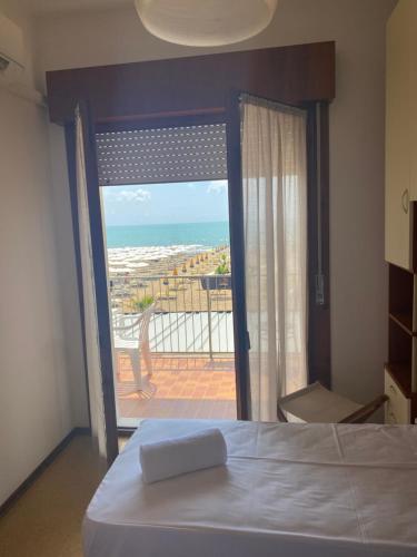 a bedroom with a bed and a view of the ocean at Villa Garda in Lido di Jesolo
