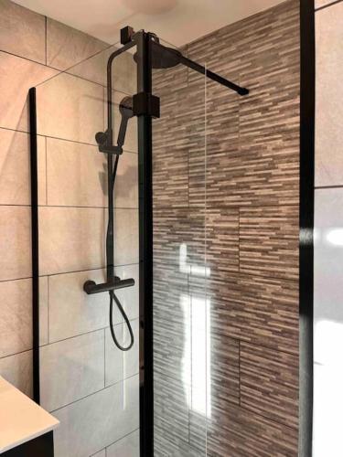 a shower with a glass door in a bathroom at Potters Loft, Bowness Centre, Parking, Lake Access in Bowness-on-Windermere