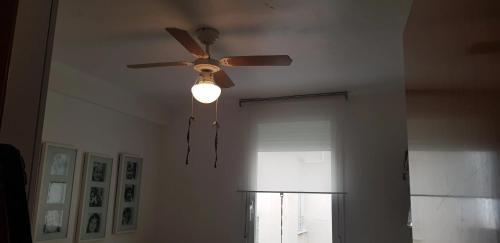 a ceiling fan in a living room with a window at Modern Apartment in Calafell + Terrace in Calafell