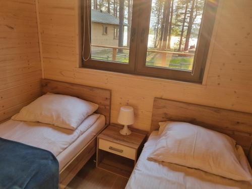 Postel nebo postele na pokoji v ubytování Magdalenka Domek z Widokiem Na Jezioro