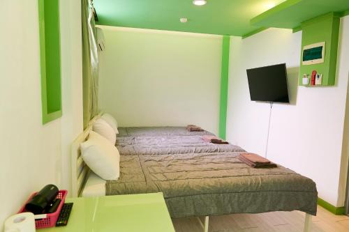 a small bedroom with a bed and a desk at Travelers A Korea Hostel in Seoul