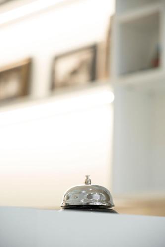a silver bell sitting on top of a counter at Hotel Blue Days in Borsh