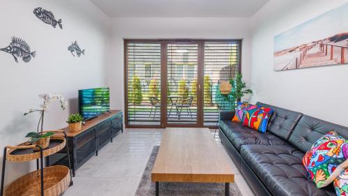 a living room with a couch and a table at Belnihel, Sun & Snow in Hel
