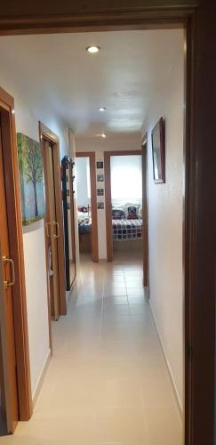 a hallway with doors and a room with a bed at Modern Apartment in Calafell + Terrace in Calafell