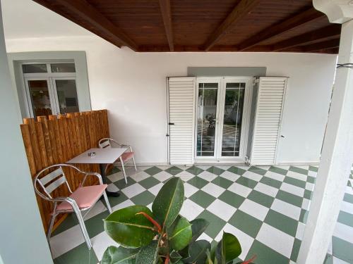 a patio with a table and chairs and a table and a floor at Yard Paradise in Dhërmi