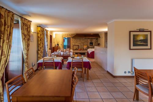 a restaurant with tables and chairs in a room at Hotel Rural Quinta de Sao Sebastiao in Barroselas