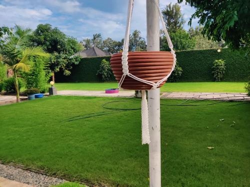 a basket hanging from a pole in a yard at Garden View with detached Bathroom in Arusha