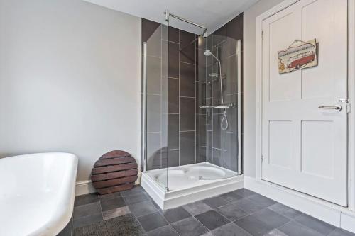 a bathroom with a shower with a glass door at The Old Post Office 5 mins Drive to Alton Towers in Alton