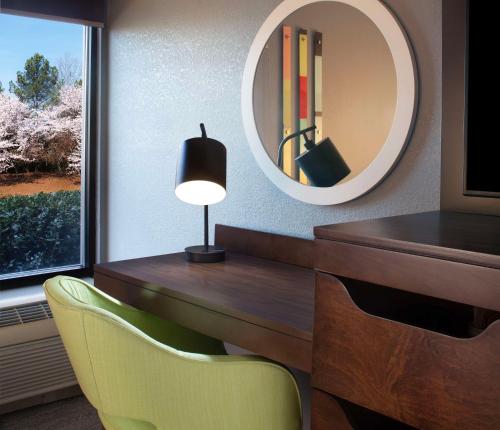 a desk with a lamp and a chair and a mirror at Hampton Inn Hotel Atlanta-Southlake in Morrow