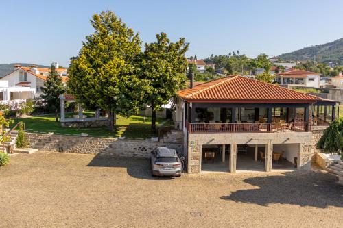 a car parked in front of a house at Hotel Rural Quinta de Sao Sebastiao in Barroselas