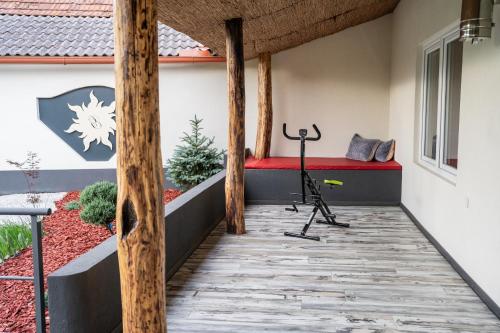 a patio with a red bench and a treadmill at Apartma in wellness Čista fantazija in Velika Polana