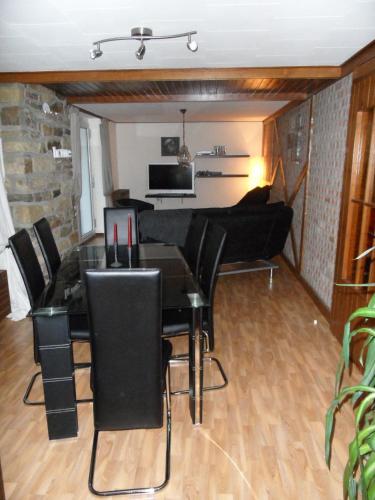 a living room with a table and a couch at The Cottage and The Loft in Amblève
