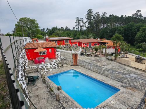 an aerial view of a house with a swimming pool at Tropical Dream Farm in Vouzela