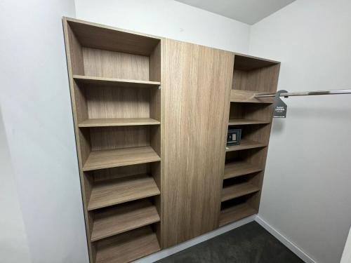 a closet with wooden shelves in a room at Hotel Grand in Čáslav