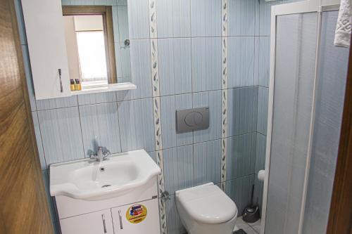 a small bathroom with a sink and a toilet at Ürgüp Elit Otel in Ürgüp
