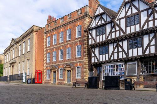 a large brick building with a red phone booth in front of it at The White Hart Hotel Lincoln in Lincoln