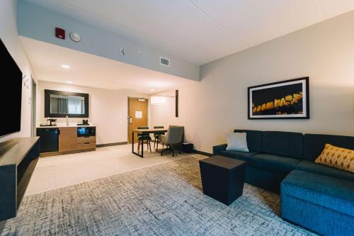 a living room with a couch and a table at Embassy Suites By Hilton Gatlinburg Resort in Gatlinburg