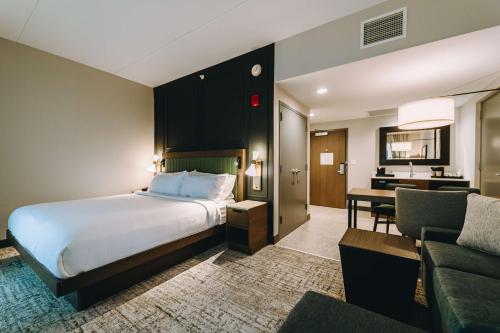 a hotel room with a bed and a desk at Embassy Suites By Hilton Gatlinburg Resort in Gatlinburg
