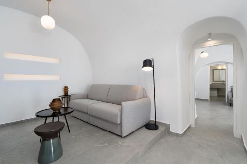 a living room with a couch and a table at Petit Palace Suites in Fira