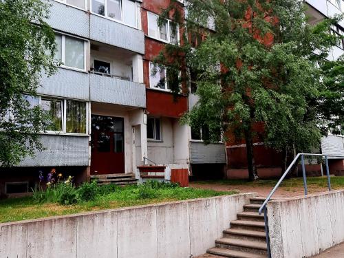 a building with stairs in front of it at Between Lake and Sea in Liepāja