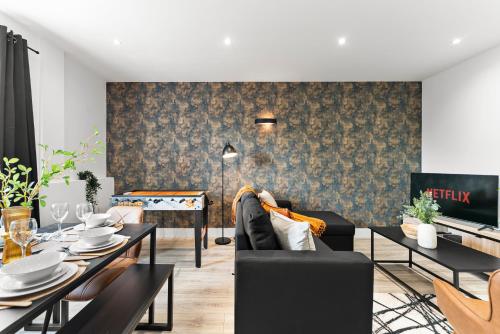 a living room with a couch and a table at Stylish Two-Bedroom Flat in Norwich in Norwich