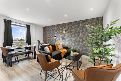 a living room with a couch and a table at Stylish Two-Bedroom Flat in Norwich in Norwich