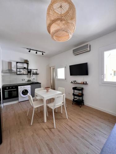 a living room with a white table and chairs at BISCOTTAI Port Apartments in Trapani