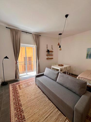 a living room with a couch and a bed at BISCOTTAI Port Apartments in Trapani