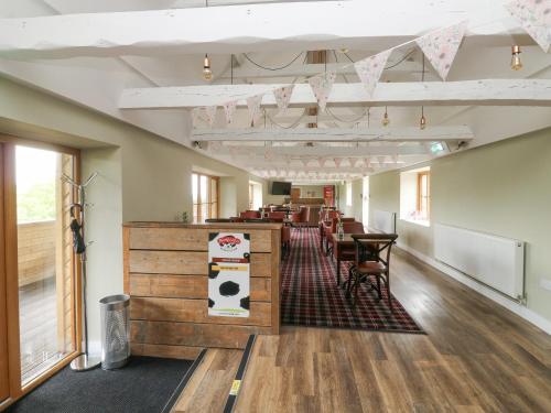 a room with tables and chairs in a building at Harcombe House Bungalow 1 in Newton Abbot