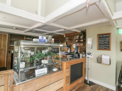 a restaurant with a counter with a display case at Harcombe House Bungalow 1 in Newton Abbot