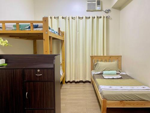 a small bedroom with a bunk bed and a ladder at Emma's Comfy Space in Manila