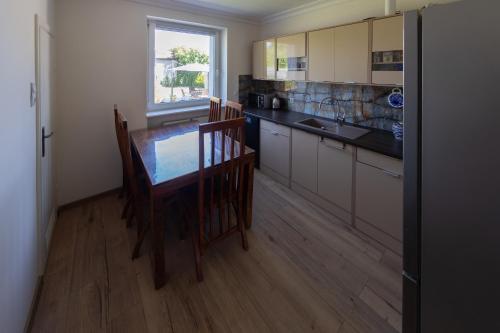 a kitchen with a table and chairs and a window at 75 m2 Apartment - Private House in Rumia