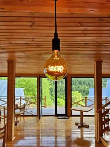 a light bulb hanging from the ceiling of a room at Cozy Cottages in Mestia