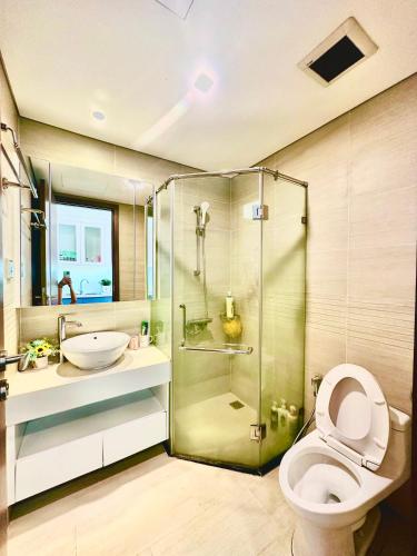a bathroom with a shower and a toilet and a sink at Deluxe Studio Next National Convention Centre And Marriott Hotel in Hanoi