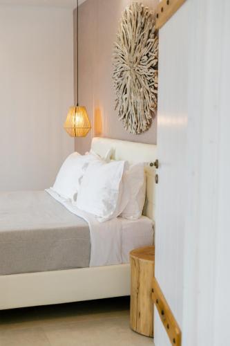 a bedroom with a bed with white pillows at Naxos Finest Hotel & Villas in Naxos Chora