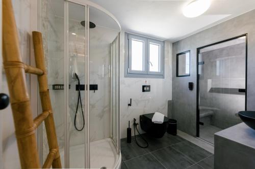 a bathroom with a shower and a toilet and a sink at Naxos Finest Hotel & Villas in Naxos Chora