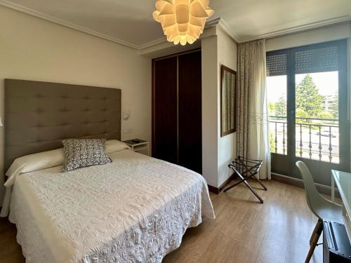 a bedroom with a bed and a large window at Hotel Eurowest in Salamanca