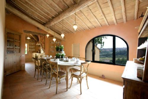a large dining room with a table and chairs at Podere La Strega in Siena