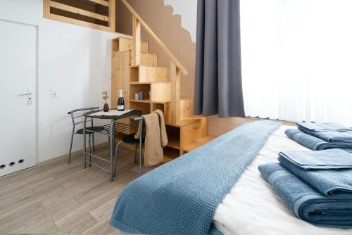 a bedroom with a bed and a table with a ladder at Apartments am Schlosspark in Senftenberg